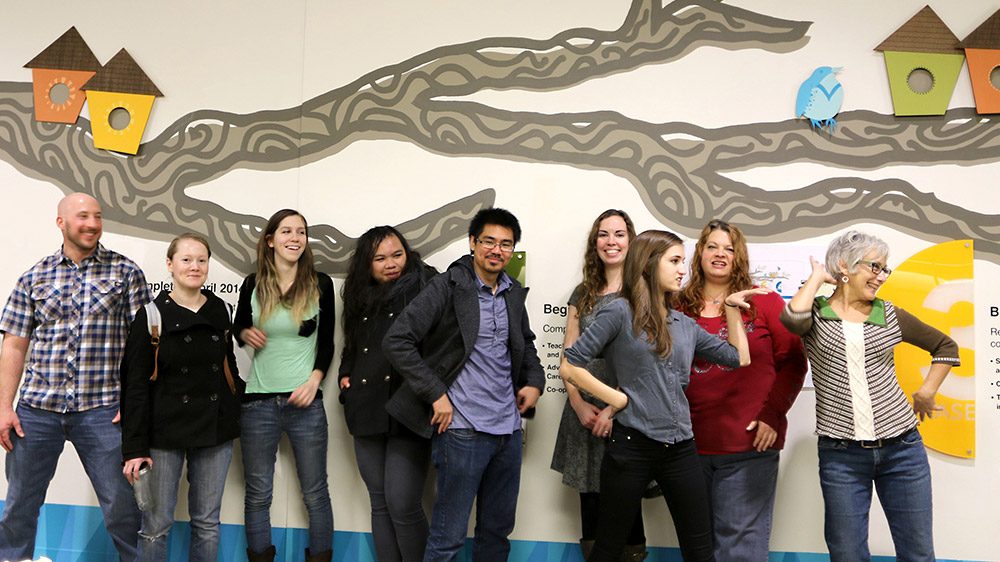 Students in front of a mural they designed at Sylvania Campus