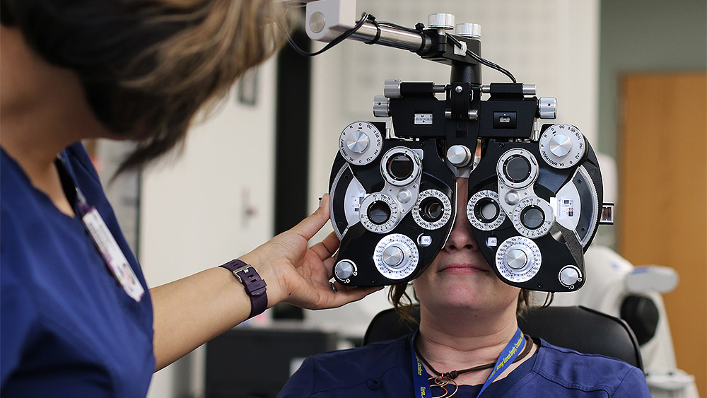 Student working with ophthalmic testing equipment