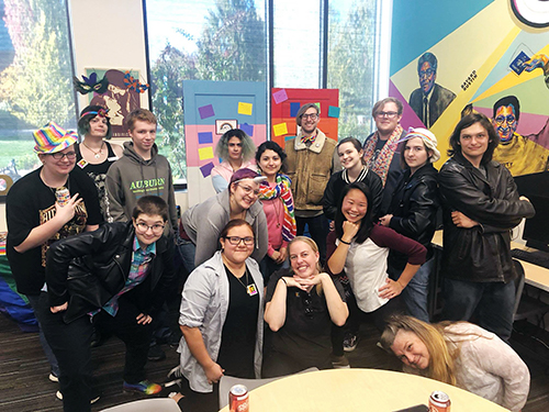 Diverse group of students posing together in the Rock Creek Queer Resource Center