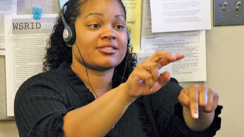 Student practicing sign language in a classroom
