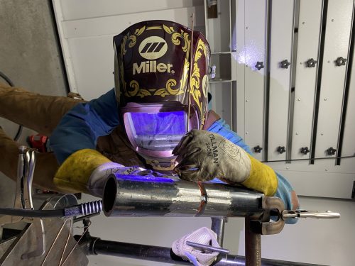 Student welding in protective gear