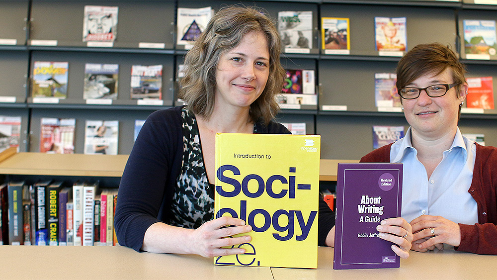 Instructors holding books about sociology