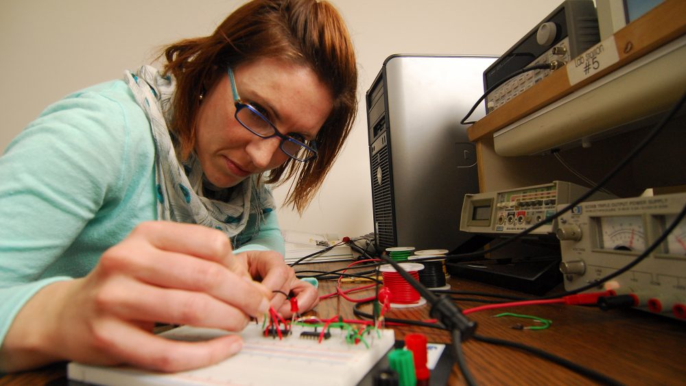 Woman working on engineering project in classroom